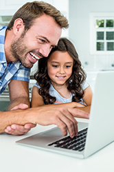 Father and Daughter clicking links on computer